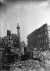 [Henry Street, side of G.P.O. shelled, mass of rubble, Nelson's Pillar in distance]