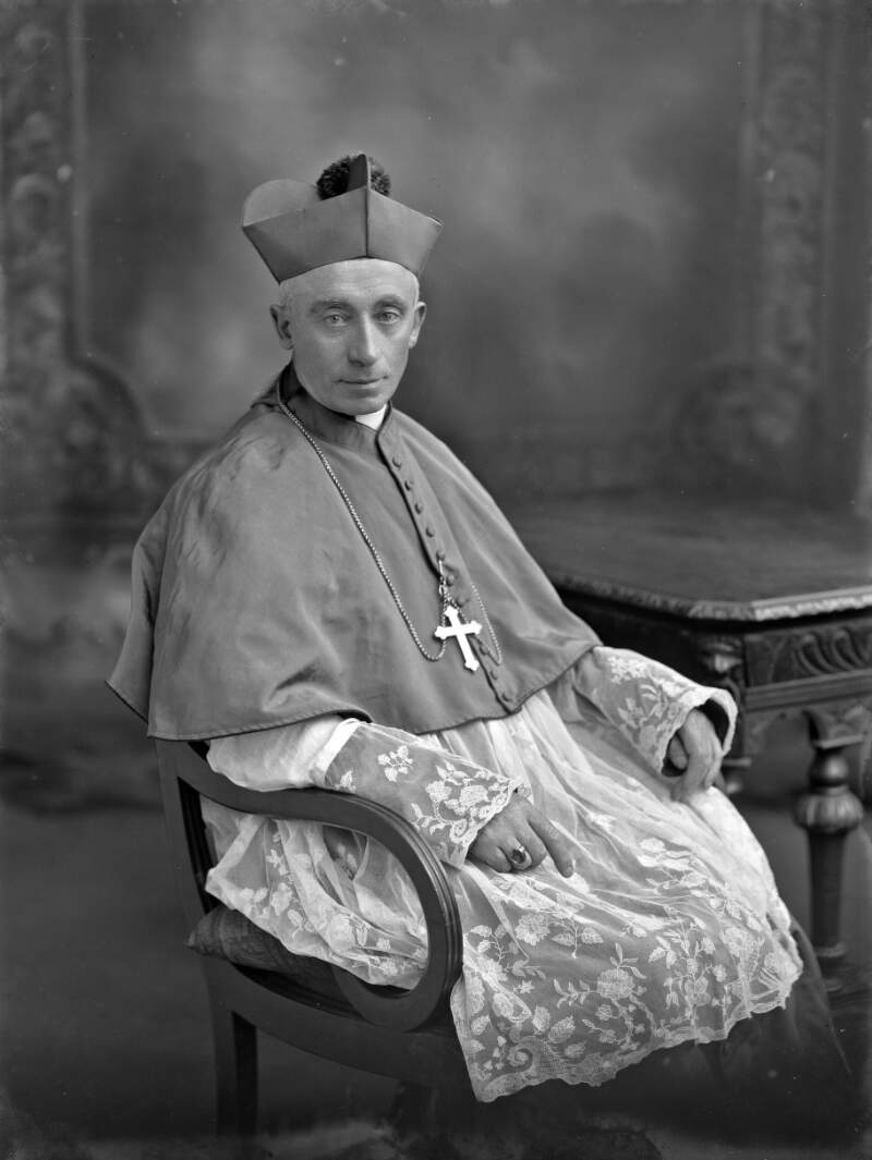 [Most Rev. Keane seated, three-quarter length portrait]