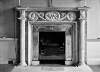 [Pillared fireplace with classical mantel plaques displaying lion and child figures, portraits, Ely House, Dublin]