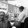 [Shopper with basket, young girl, Moore Street Market, Dublin]