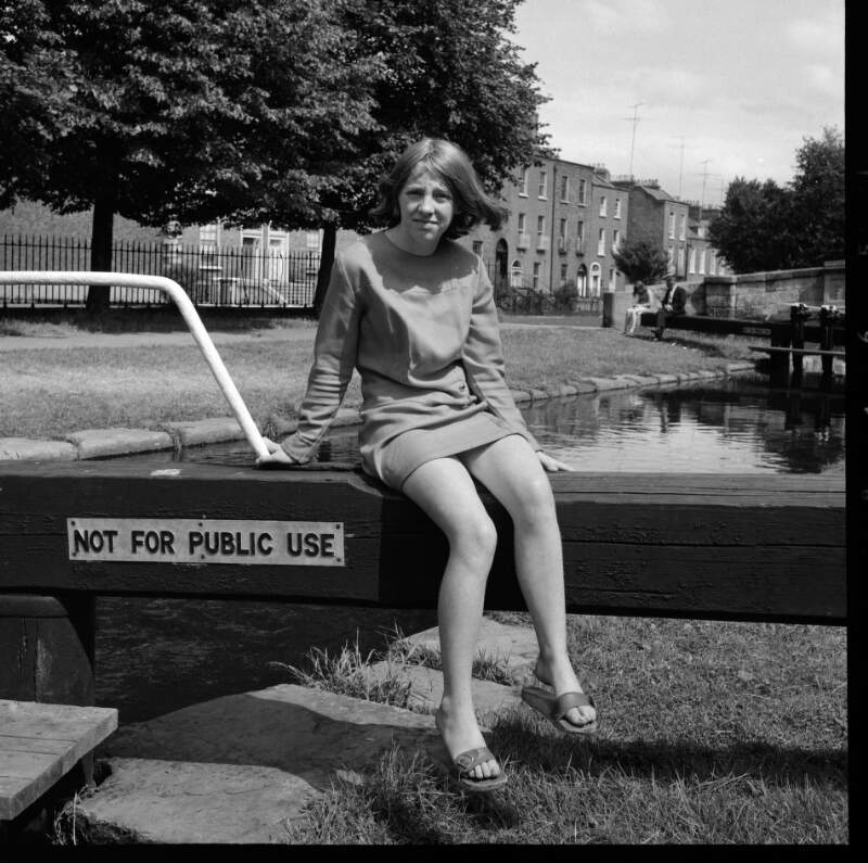 [Young girl sitting on lock gate, Grand Canal near Huband Bridge, Dublin]
