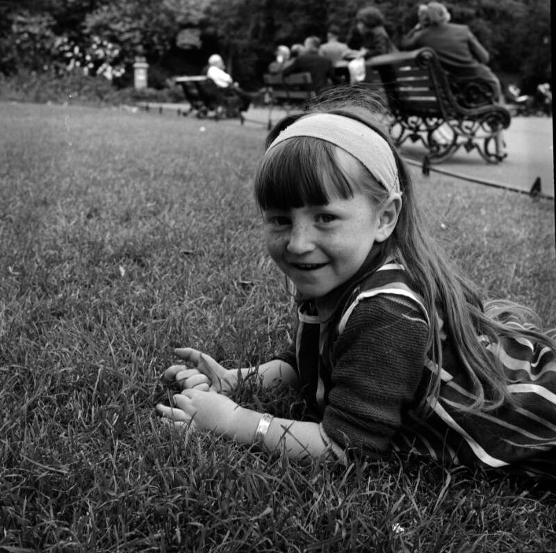 [Little girl lying in grass, St. Stephen's Green, Dublin]