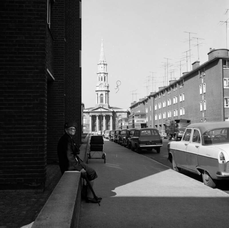 [Old woman on Hardwicke Street, St. George's Church in background, Dublin]