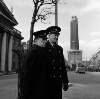 [Two guards on O'Connell Street with G.P.O and half-demolished Nelson Pillar in background, Dublin]