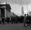[Shoppers crossing O'Connell Street near G.P.O and half-demolished Nelson Pillar, Dublin]