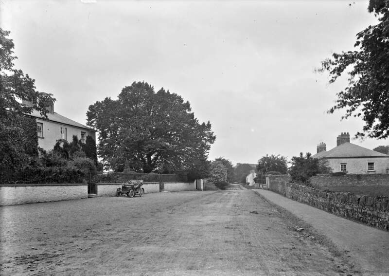 [Roadway showing motor car parked outside house, Mountmellick, Co. Laois]