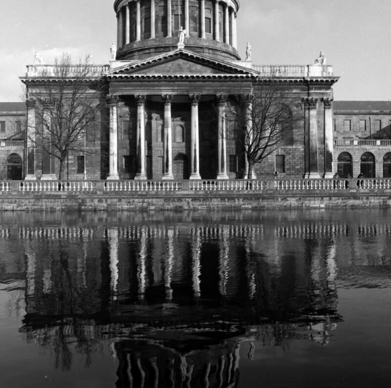 [View of Four Courts from Merchants Quay, also shows reflection in River Liffey, Dublin]