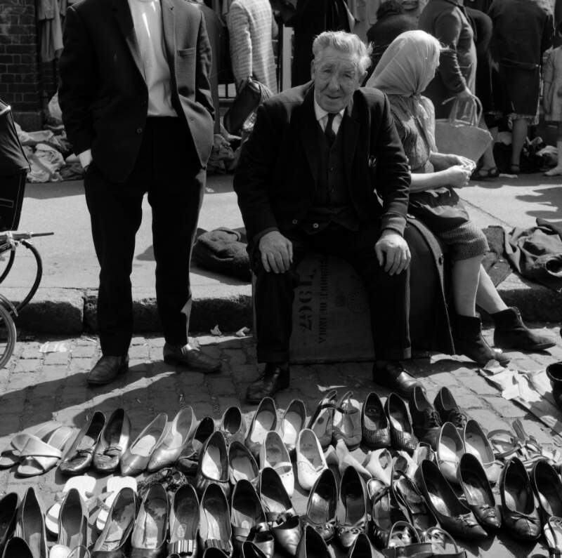 [Man selling secondhand shoes at Cumberland Street Market, Dublin]