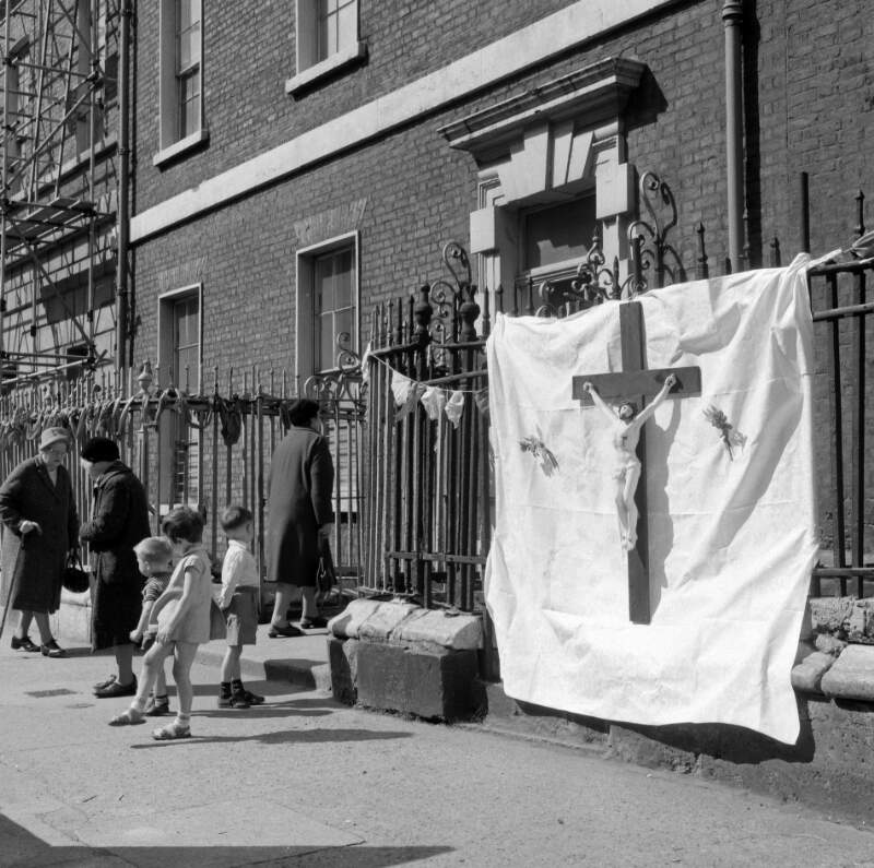 [Old women and children near large crucifix, Corpus Christi, Henrietta Street, Dublin]