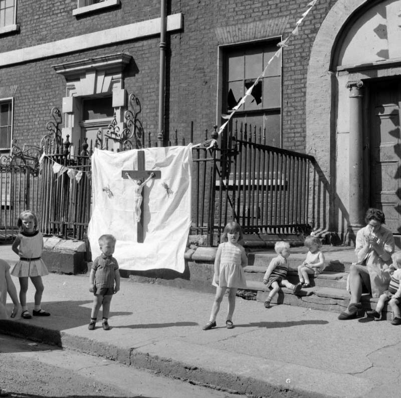 [Children playing on steps near large crucifix, Corpus Christi, Henrietta Street, Dublin]
