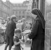 [Nun collecting for charity, little boy also in view, Moore Street Market, Dublin]
