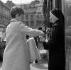 [Woman giving donation to nun, Moore Street Market, Dublin]