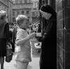 [Boy giving donation to nun, Moore Street Market, Dublin]