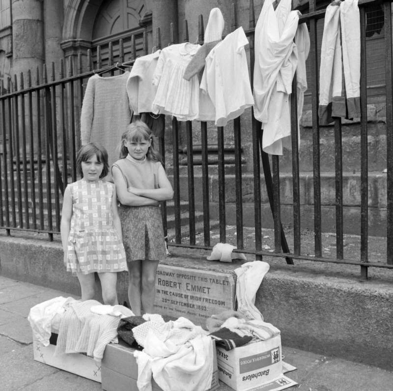 Elizabeth (Lily) Collins and her friend Angela Arnold, selling secondhand clothes in aid of the charity Gorta outside St. Catherine's Church, Thomas Street, Dublin