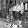 [Elizabeth (Lily) Collins and her friend Angela Arnold, sorting through secondhand clothes they are selling in aid of the charity Gorta, outside St. Catherine's Church, Thomas Street, Dublin]
