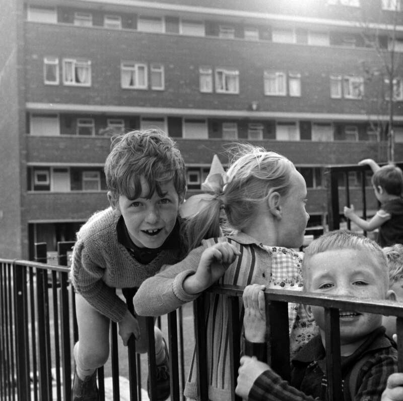 [Children playing by railings in front of block of flats, Dublin]
