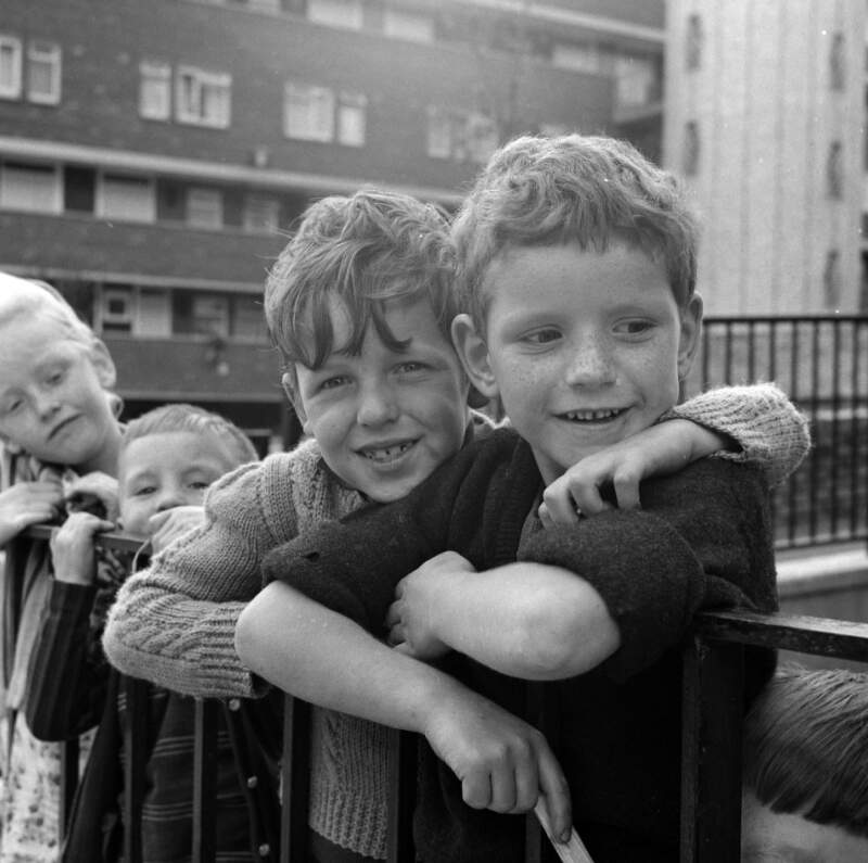 [Children playing by railings in front of block of flats, Dublin]