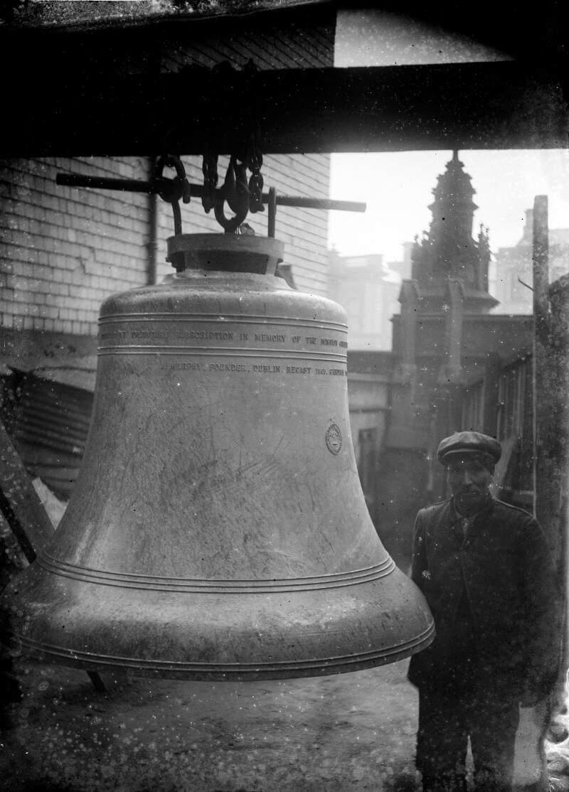 [Man beside a big bell, St. Patrick's Cathedral, Dundalk, 1906]