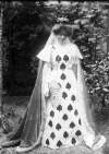 [Woman dressed as "May, Queen of Hearts", with fan and headdress, Ireland]
