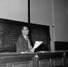 [Patrick Kavanagh giving poetry lecture, holds papers/notes in right hand, University College Dublin]