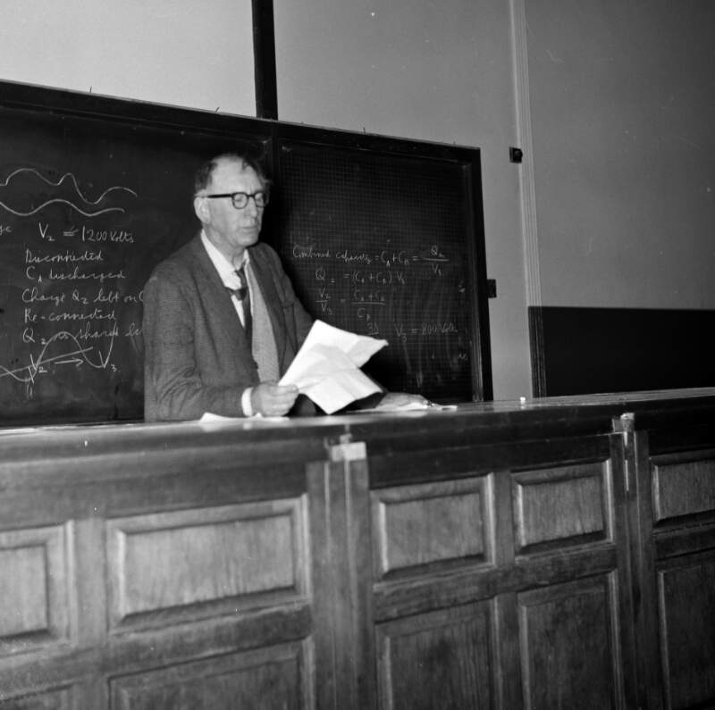 [Patrick Kavanagh giving poetry lecture, holds paper/notes in right hand, University College Dublin]