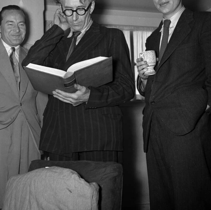 [Michael Scott, Patrick Kavanagh reading from book, Anthony Cronin, Scott's house, Bloomsday, Sandycove, Co. Dublin]
