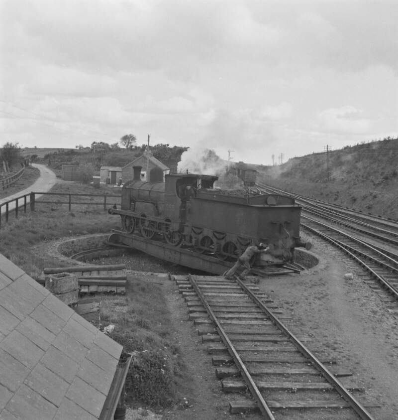 [Man pushing steam train on a turn table, Kilfree Junction, Co. Sligo]