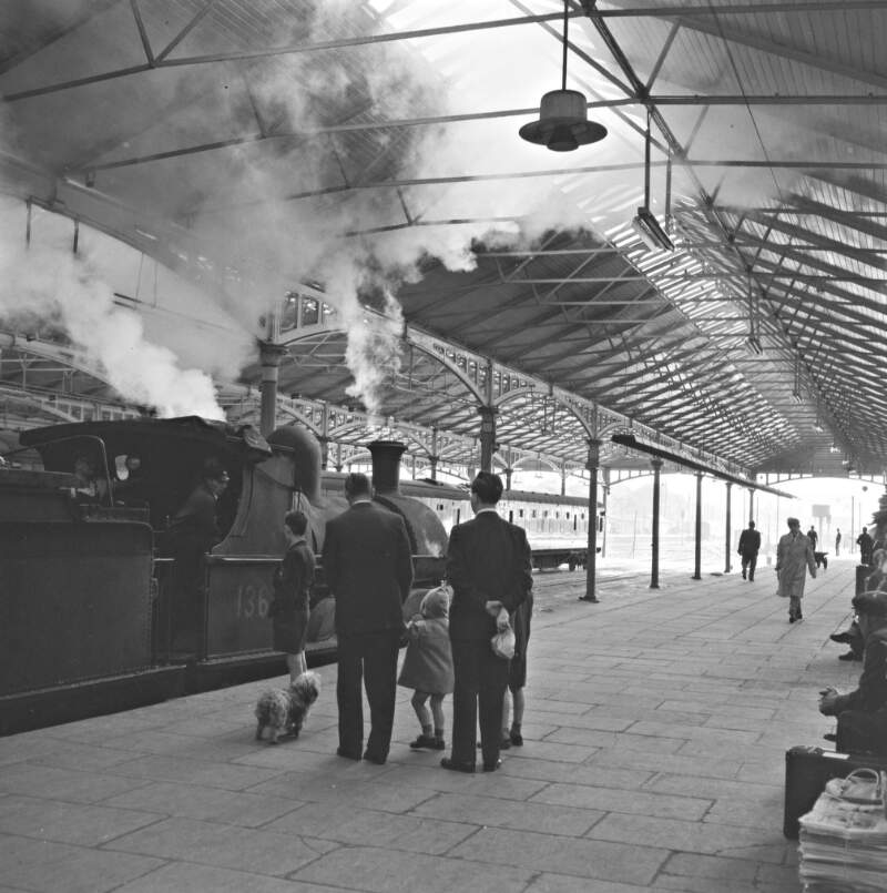 [People waiting on a railway platform at Kingsbridge station as a steam train arrives, Dublin]