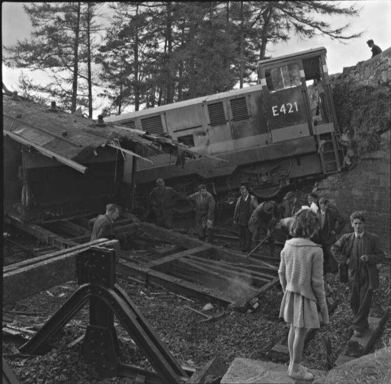 [Aftermath of a train crash at Newbridge with a girl watching railway workers clearing the area, Newbridge, Co. Kildare]
