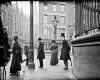 [Man with umbrella standing at the junction of Nassau Street, Grafton Street and Suffolk Street]