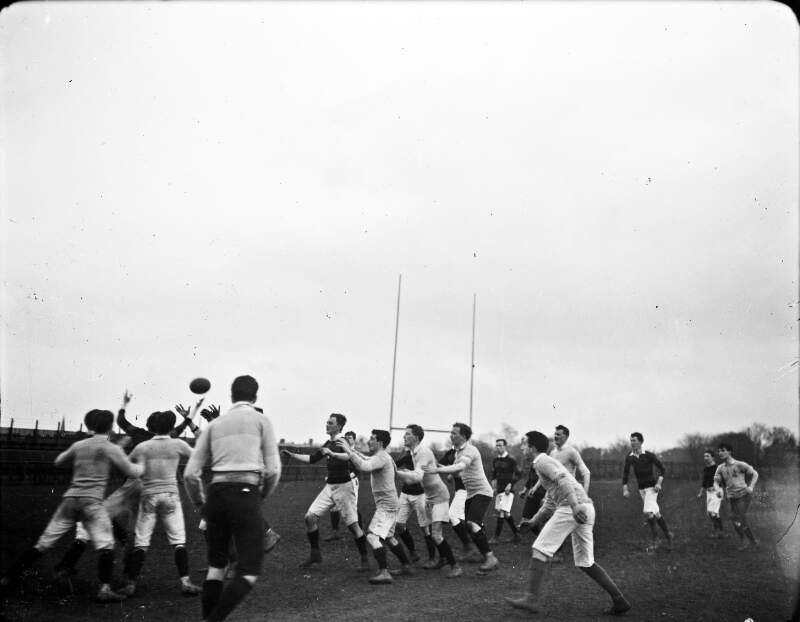 [Young men playing rugby]