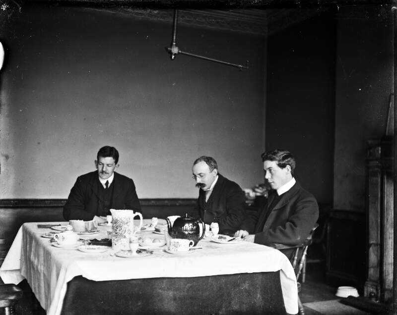 [Three gentleman eating breakfast at table]