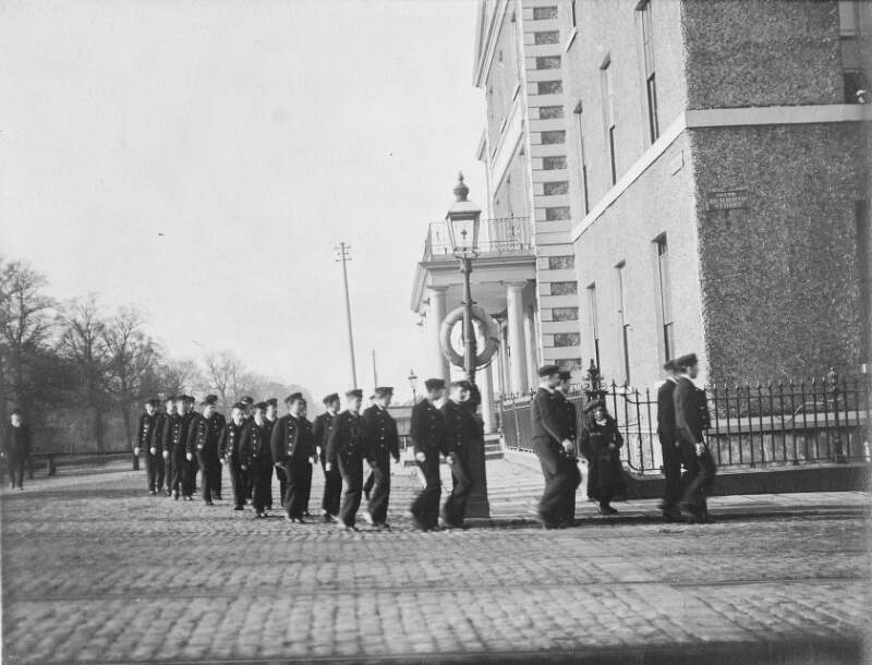 [Group of boys in uniform marching at the corner of Portobello and Richmond Street South]