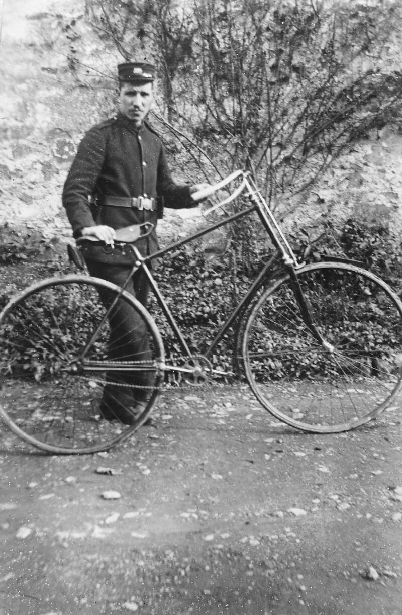 [Man in uniform with bike]