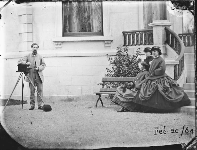 [Lord Dunlo with stereo camera facing three Dillon sisters at base of steps, Clonbrock House]