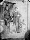 [Two workmen standing outside porch, probably on Clonbrock estate]