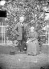 [Portrait of an elderly couple, possibly servants, outside Clonbrock House, Co.Galway]