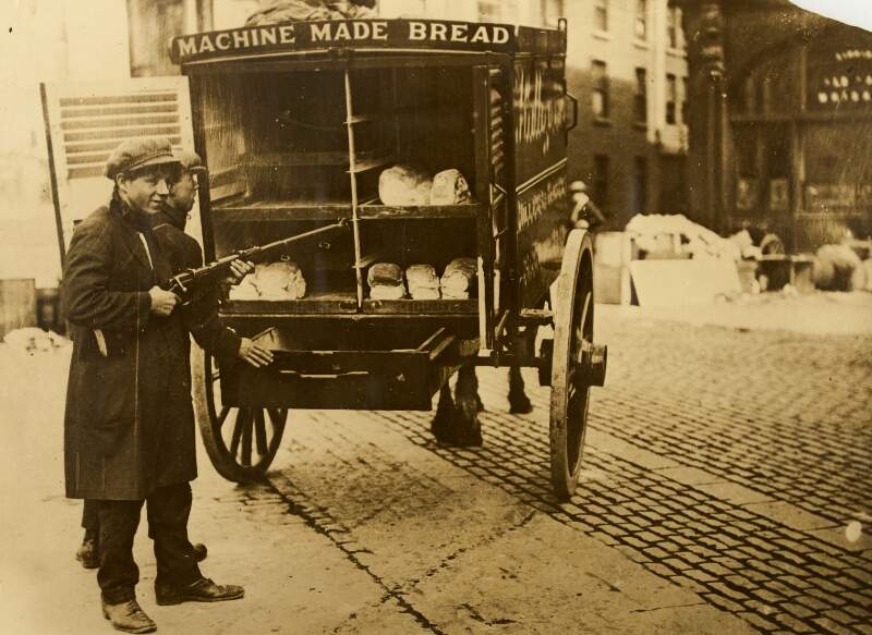 [Boys with rifles, standing beside bread cart, during the Irish Civil War]