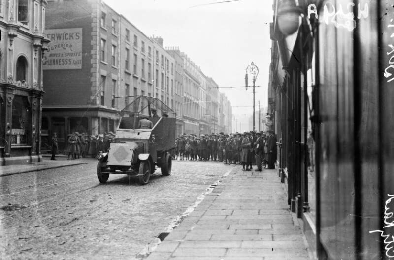 [Crowd looking at armoured car on Dublin street]