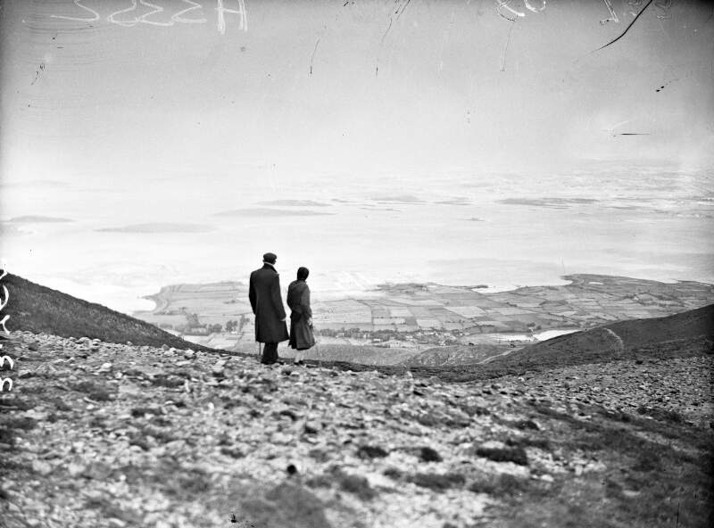 [Couple standing on Croagh Patrick looking out at Clew Bay]