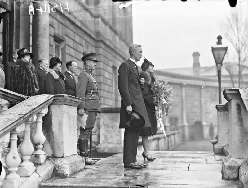 [New Governor General James MacNeill and his wife standing outside the official entrance of Leinster House. ]