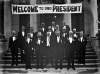 [Rotary convention, Killarney. Group in dinner dress on the steps of the Great Southern Hotel. Banner reads "Welcome to our president"].