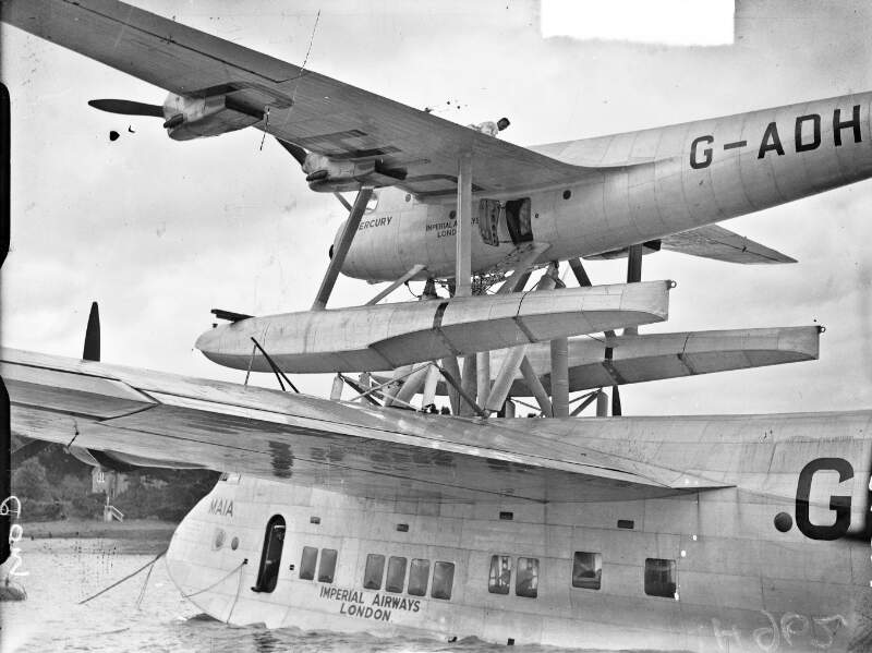 [Short-Mayo Composite of Imperial Airways at Foynes. Large 4-engined flying boat "Maia" with small seaplane "Mercury" on top].