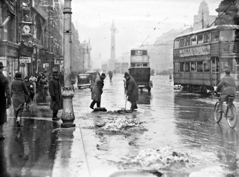 [Men clearing snow on O'Connell Street, Dublin]