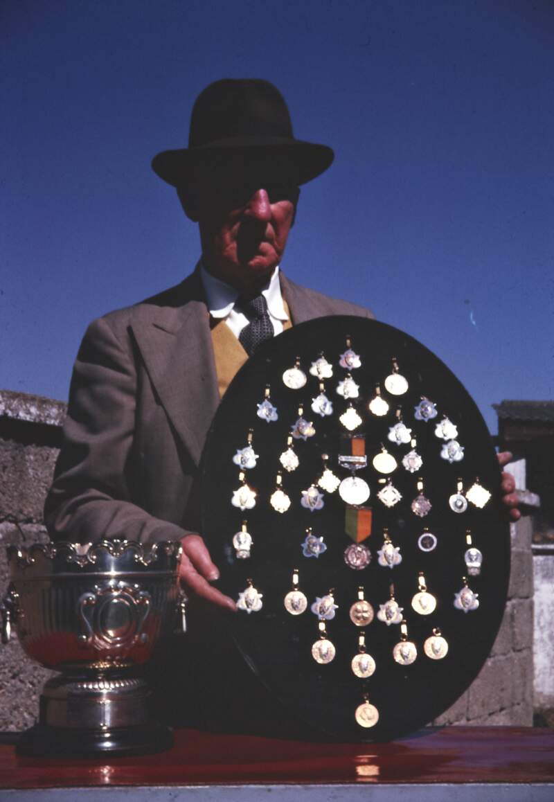 [Michael A Walker, holding a display of medals, 29 April 1962]