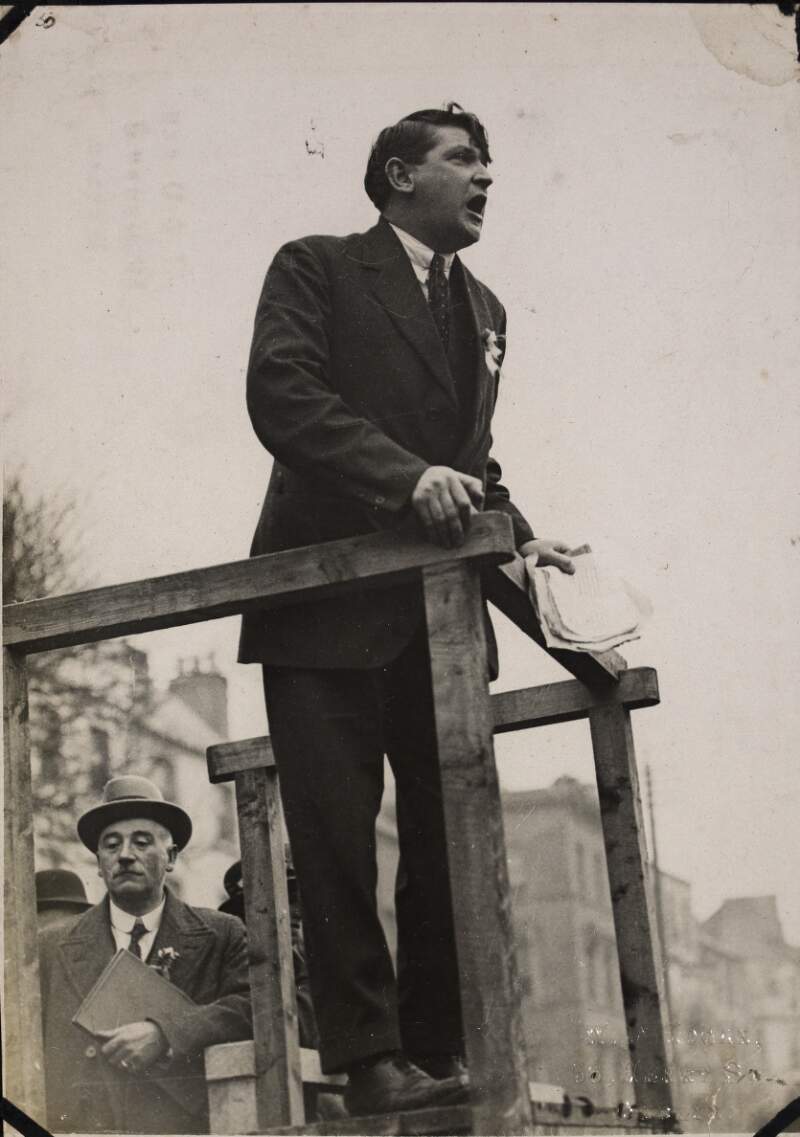 [View of Michael Collins speaking from podium at Cork]
