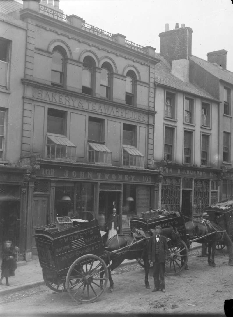 [Shops, pedestrians and delivery carts on Shandon Street, Cork]