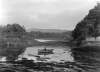 [Man rowing at boat, close to the water's edge : near Castletown, Berehaven, Co. Cork]