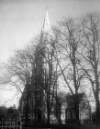 [Exterior of a church surrounded by trees, in an unknown location]
