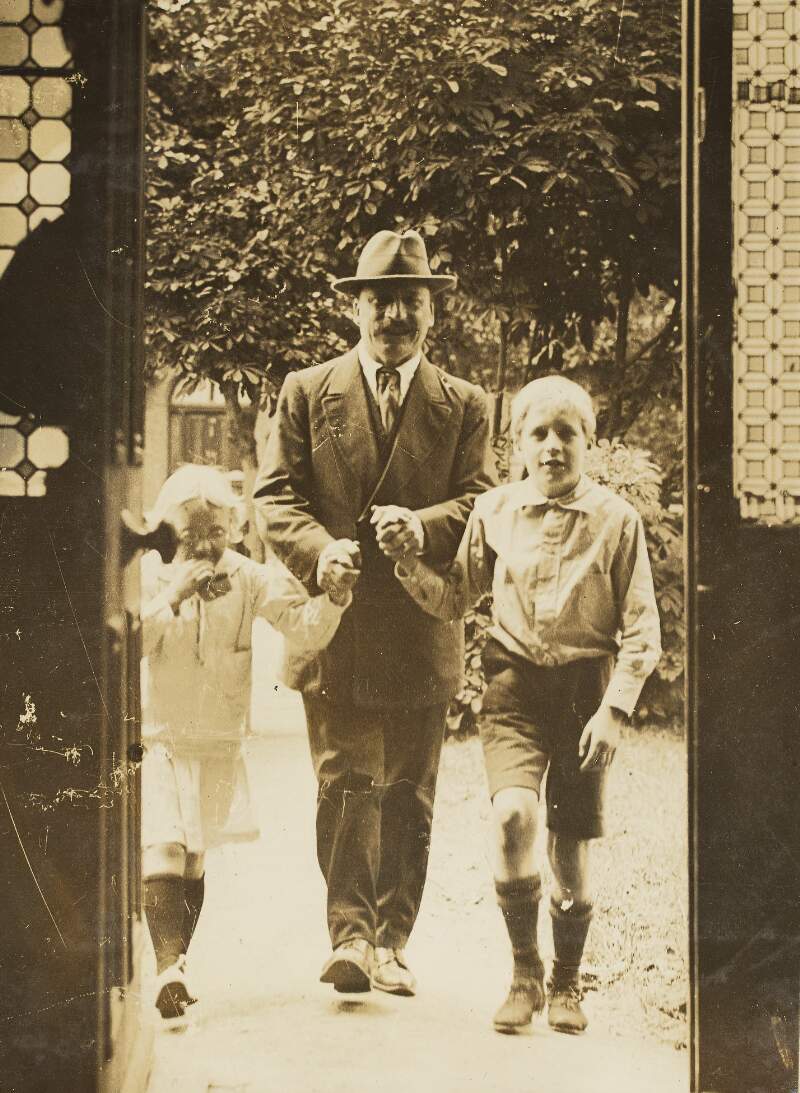 [Arthur Griffith entering his home with his two children]